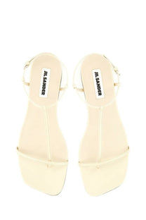 Cream-colored jil sander women’s leather sandal with minimalist design and thin straps in white color