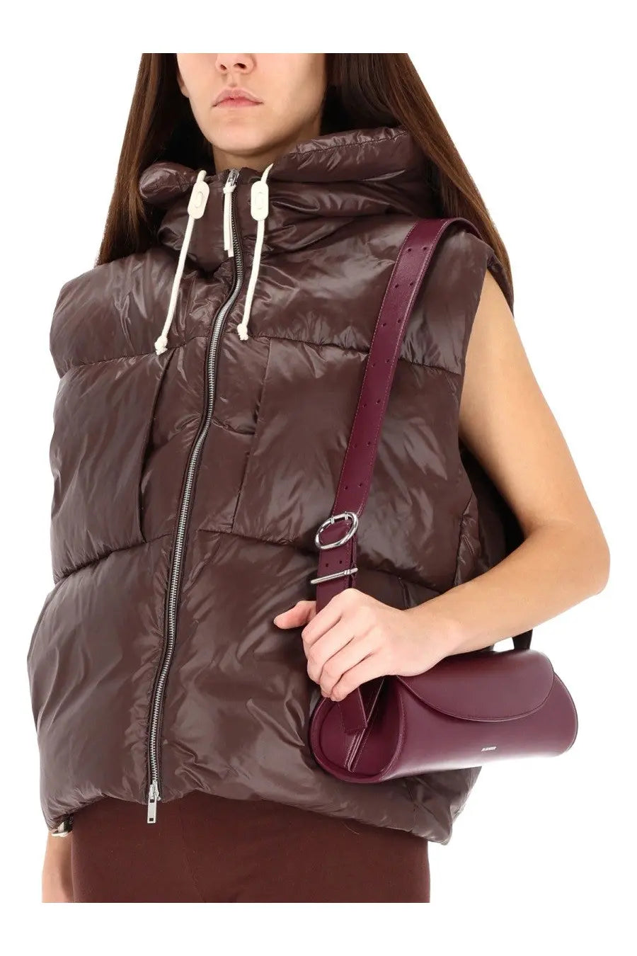 A sleek burgundy leather crossbody bag with a minimalist design and silver metal ring detail by jil sander