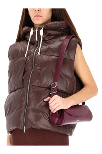 A sleek burgundy leather crossbody bag with a minimalist design and silver metal ring detail by jil sander