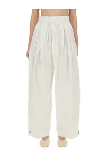 Cream-colored high-waisted wide pants with pleats drawstring waist and buttoned cuffs in cotton gabardine by jil sander