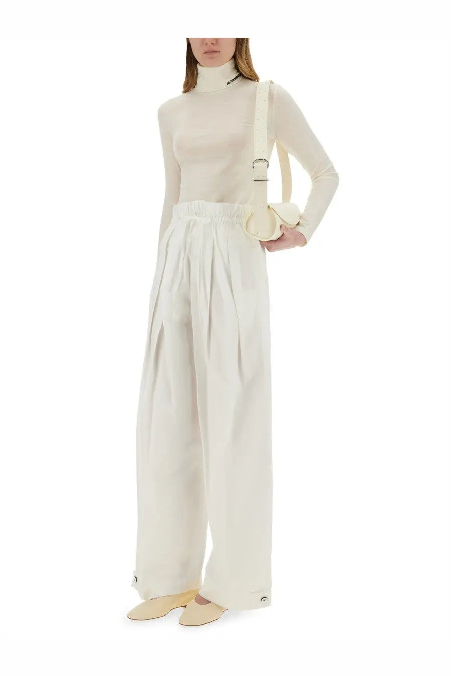 Cream-colored high-waisted wide-leg cotton gabardine trousers with pleated front and buttoned cuffs by jil sander