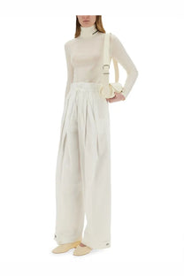 Cream-colored high-waisted wide-leg cotton gabardine trousers with pleated front and buttoned cuffs by jil sander