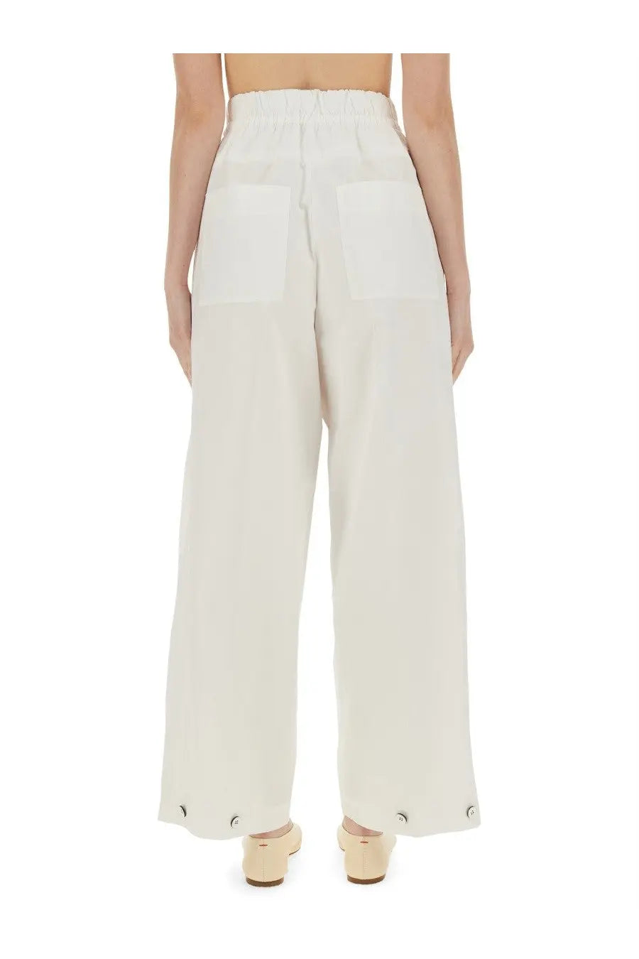 Cream-colored jil sander wide-leg cotton gabardine pants with high-waisted elastic band and buttoned cuffs