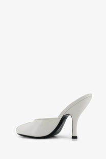 White leather jude women’s mule sandals with sleek minimalist design and black sole viewed from the back