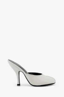 A sleek white leather Jude women’s mule sandal with black sole and heel accent for date wear