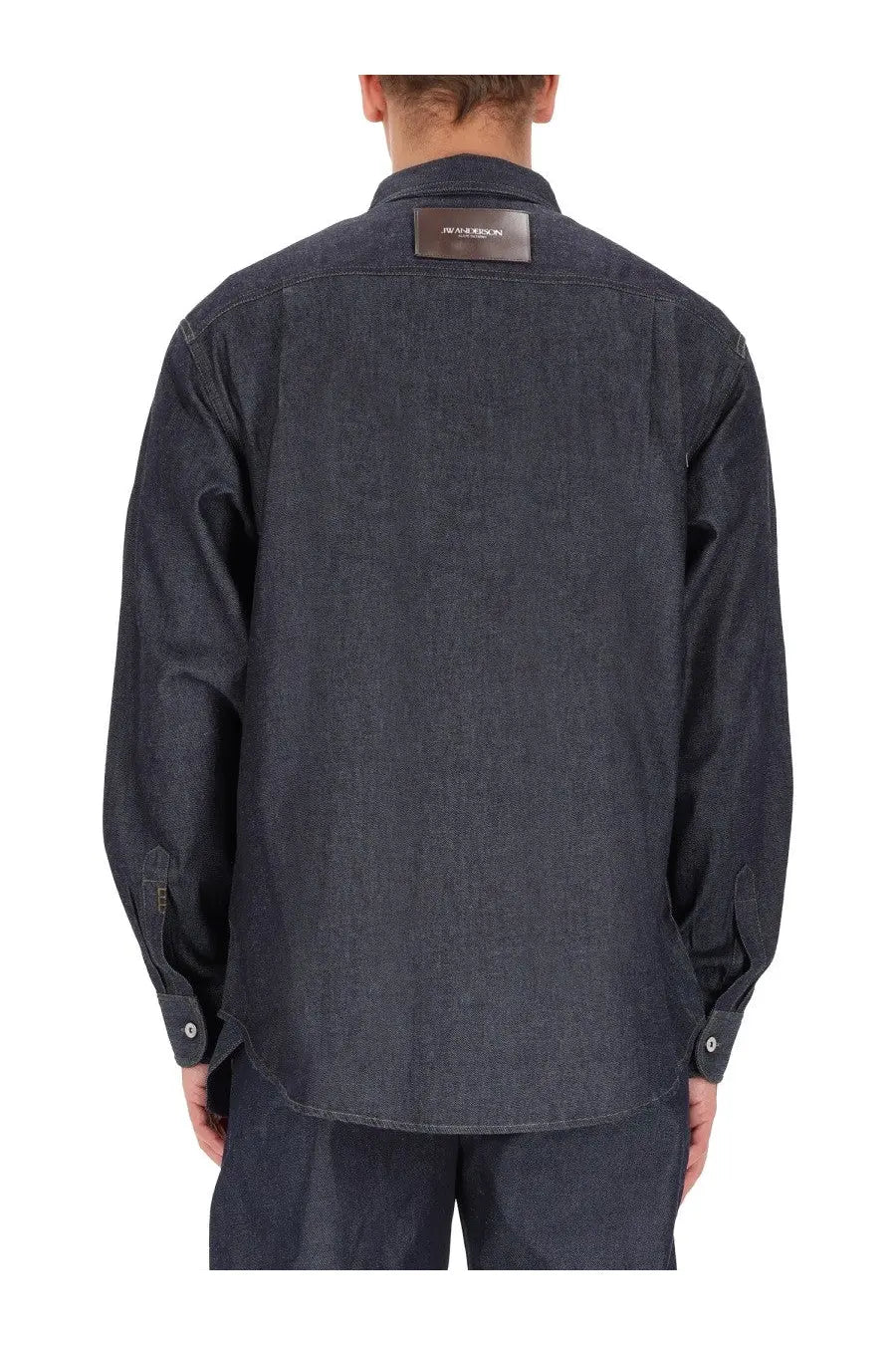 Jw anderson men’s denim shirt blue in dark indigo with a brown leather patch at the collar