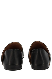 Jw anderson men’s leather slipper shoe black showing black leather mules with smooth finish and brown lining