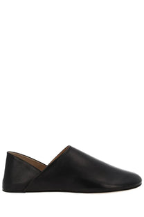 Jw anderson men’s black leather slipper shoe featuring sleek slip-on moccasin design with subtle stitching details