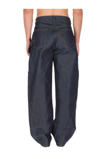 Dark indigo denim jw anderson men’s twisted workwear jeans with wide tapered legs and a high waist