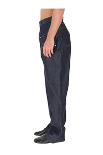 Jw anderson men’s twisted workwear jeans in dark indigo denim with diagonal seam and light contrast stitching