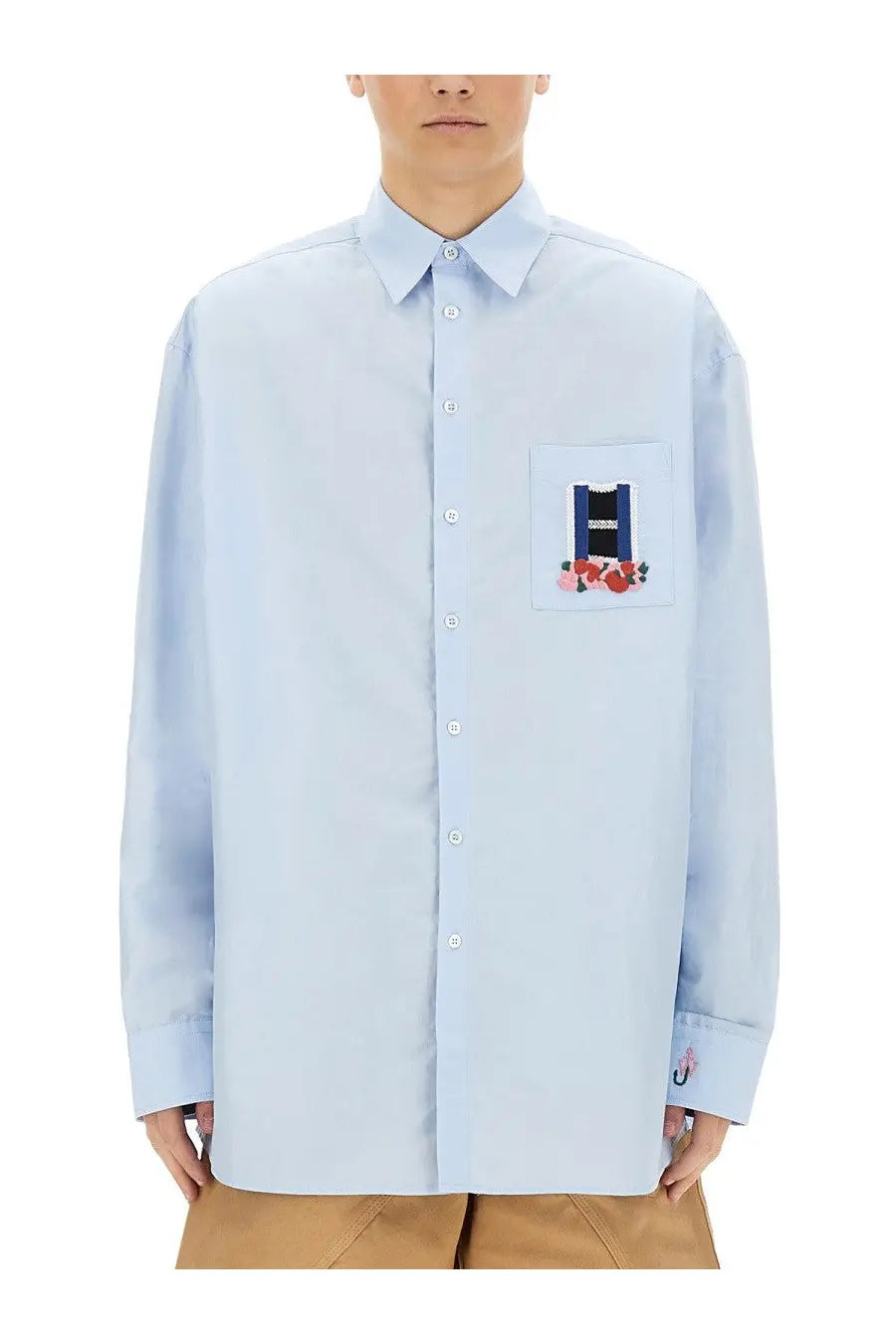 Light blue jw anderson men’s window shirt featuring a patch pocket embroidered with roses and text