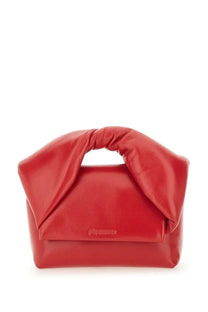 A vibrant red glossy leather jw anderson women’s bag twister small with a distinctive twisted handle and minimalist branding