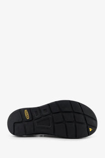 Back side of keen men’s uneek suede sneakers green showing black rubber sole with textured grid and gold keen logo