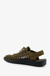Keen men’s Uneek olive green woven sandal with black rubber sole and adjustable strap closure in suede sneakers style