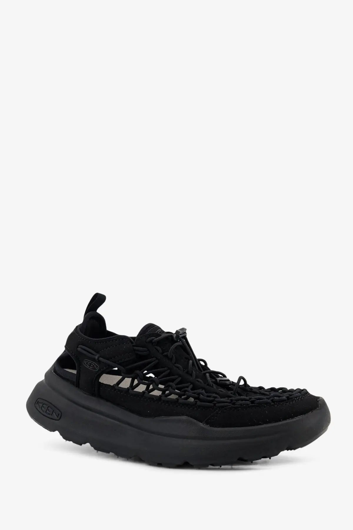 Keen men’s uneek wk suede and rubber sneakers in black with woven upper and chunky rubber sole visible from back side