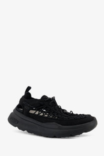 Keen men’s uneek wk suede and rubber sneakers in black with woven upper and chunky rubber sole visible from back side