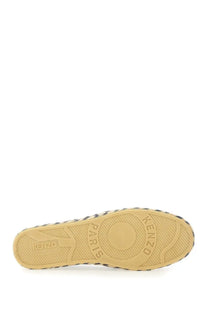 Tan rubber sole with black and white striped edge and embossed kenzo paris branding on kenzo men’s espadrilla purple