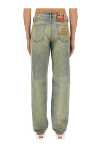 Back side of light-wash denim kenzo men’s slim bara jeans with faded distressed look embroidered pockets and red waistband label