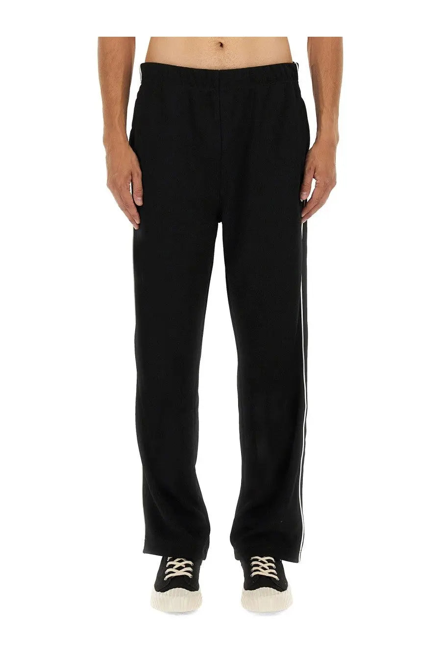 Kenzo men’s black tapered track pants with white side stripes designed for athletic and casual wear