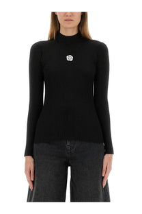 Kenzo women’s black ribbed knit turtleneck sweater with white floral emblem on the chest in jersey fabric