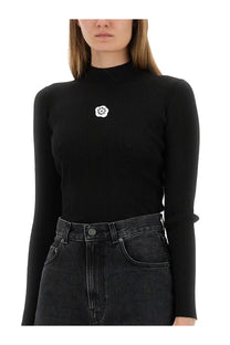 Kenzo women’s black ribbed long-sleeve jersey turtleneck top with white embroidered floral chest patch