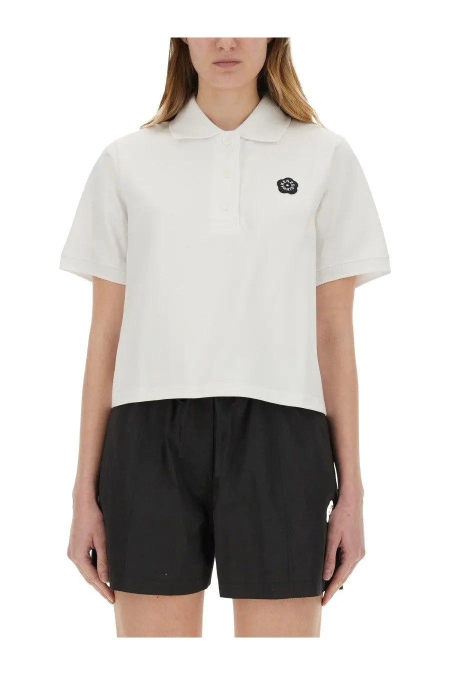 Kenzo women’s white short-sleeved polo shirt featuring black embroidered logo on left chest for casual wear