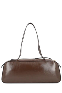 Khaite women’s brown leather handbag simona with sleek elongated design and matching shoulder strap