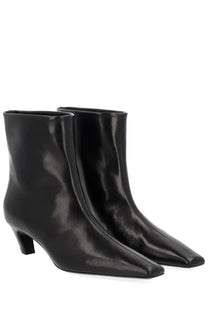 Khaite women’s Stivale Arizona black patent leather ankle boots with sleek pointed toe and low block heel
