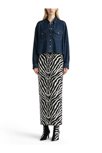 Khaite women’s top grenon blue paired with a black and white zebra-striped knit midi skirt and denim jacket with matching boots