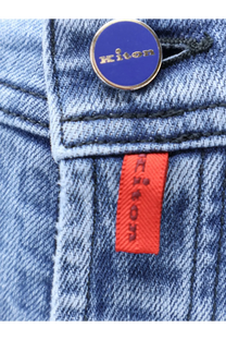 Kiton men’s blue denim jeans with circular blue and gold Kiton button and orange brand tag visible