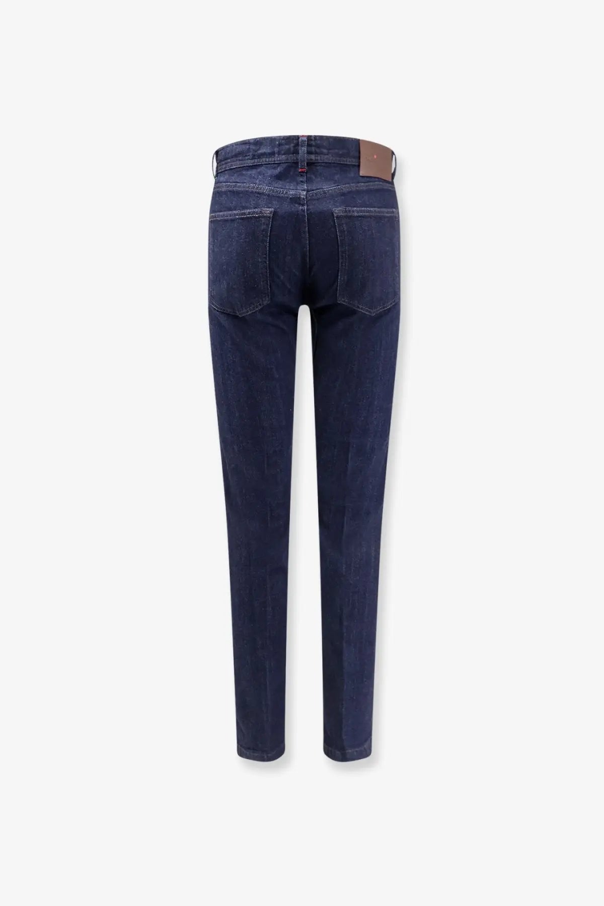 Kiton men’s cotton blend dark indigo slim fit jeans with brown leather brand patch at the waistband back view
