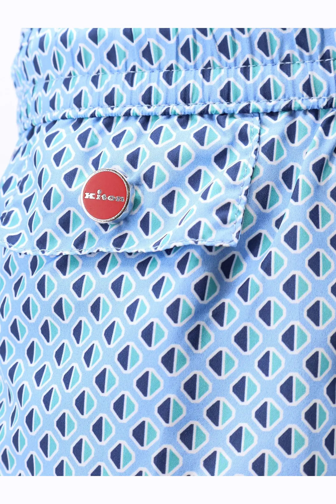 Kiton men’s nylon swim trunks in light blue with navy teal triangle pattern and red kiko brand button accent