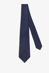 A kiton men’s silk tie in navy blue with a subtle repeating geometric pattern for formal wear