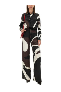 Kiton women’s printed shirt brown paired with a black and white abstract-patterned silk jumpsuit with fitted top and wide legs