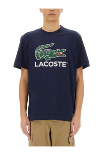 Navy blue Lacoste men’s cotton t-shirt with green crocodile logo and white Lacoste lettering on front