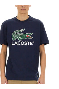 Navy blue lacoste men’s cotton t shirt with green crocodile logo red accents and white brand name lettering