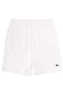 Lacoste men’s white tennis shorts with subtle textured fabric and green crocodile logo on lower right leg