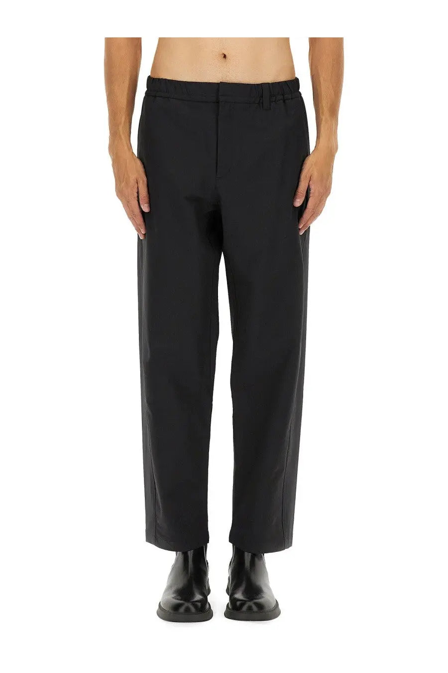 Black laminar men’s comfort tech pants with tailored straight-leg cut and subtle front pleats for a sleek fit