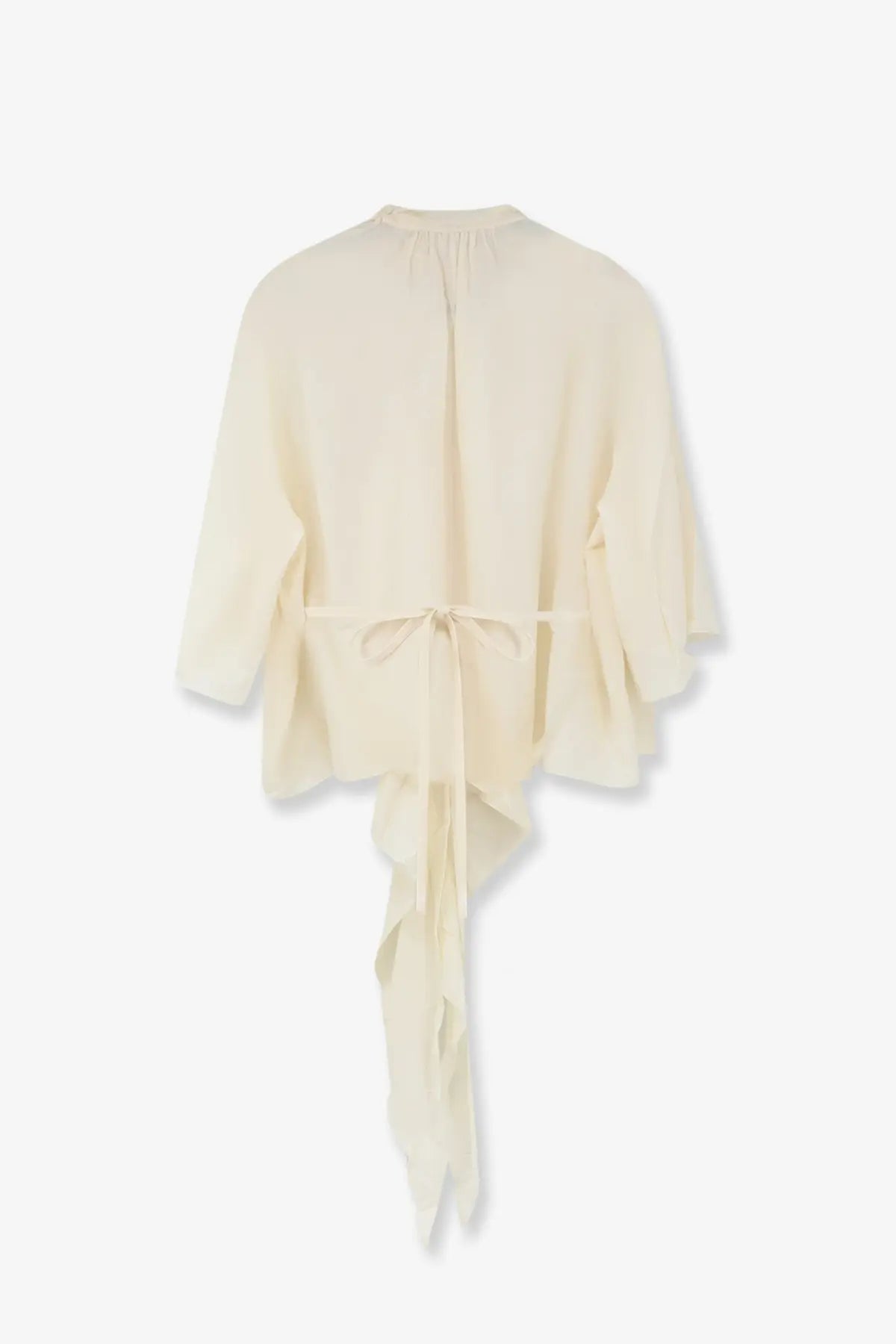 Cream-colored lightweight chiffon blouse with gathered neckline and asymmetrical ruffled hem tied at waist by lamrons