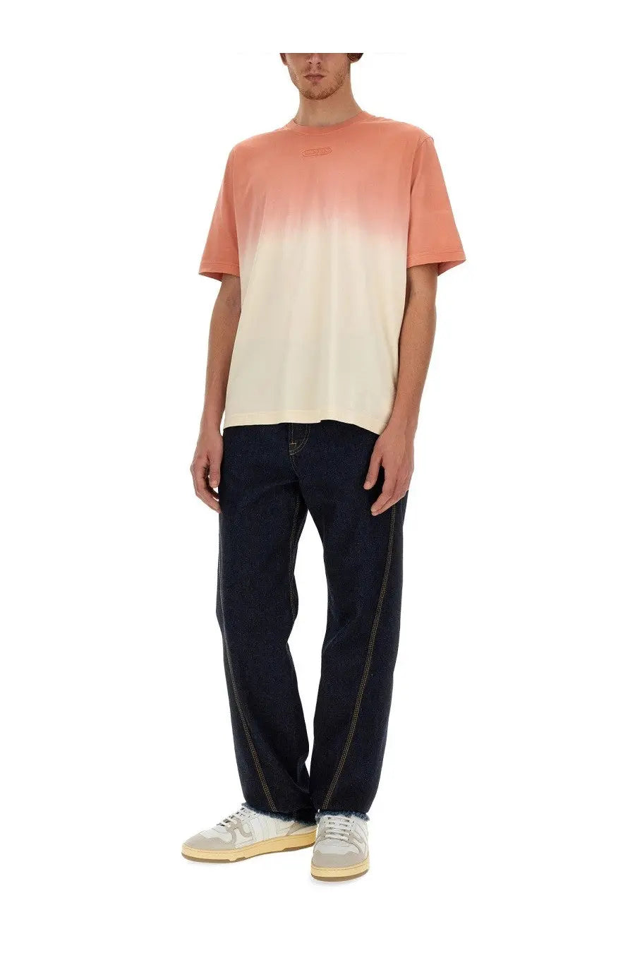 A lanvin men’s twisted jeans blue paired with a peach-to-cream gradient short-sleeved t-shirt with a relaxed fit