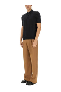 Black short-sleeved polo shirt with classic collar and button placket paired with lardini beige wool pants