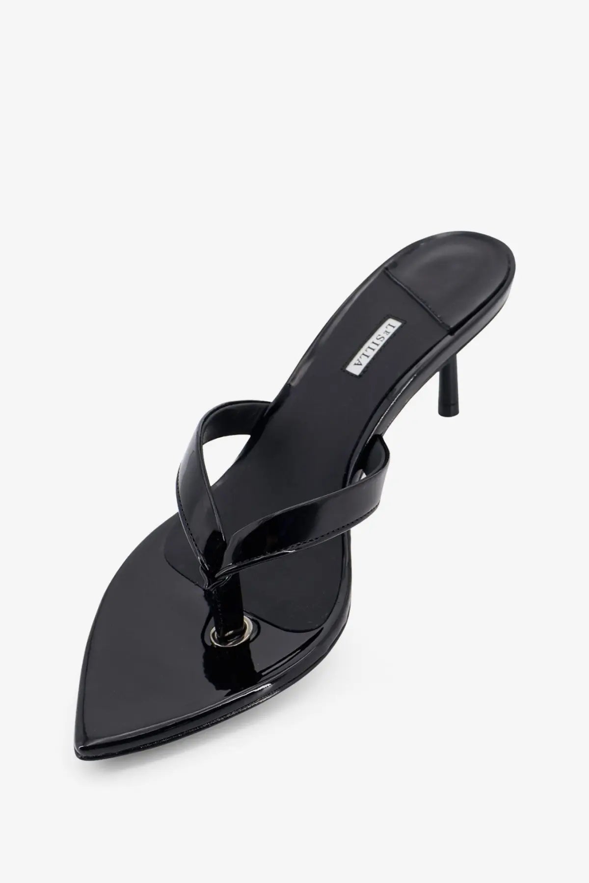 Le silla women’s Gisele black patent leather thong sandal with slender heel and pointed toe shown from the back