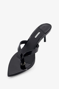 Le silla women’s Gisele black patent leather thong sandal with slender heel and pointed toe shown from the back