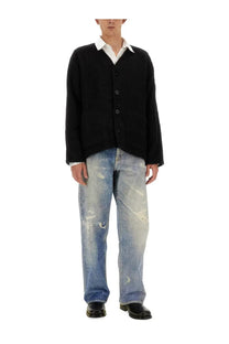 Our Legacy men’s black knit cardigan with button closure worn over a white collared shirt