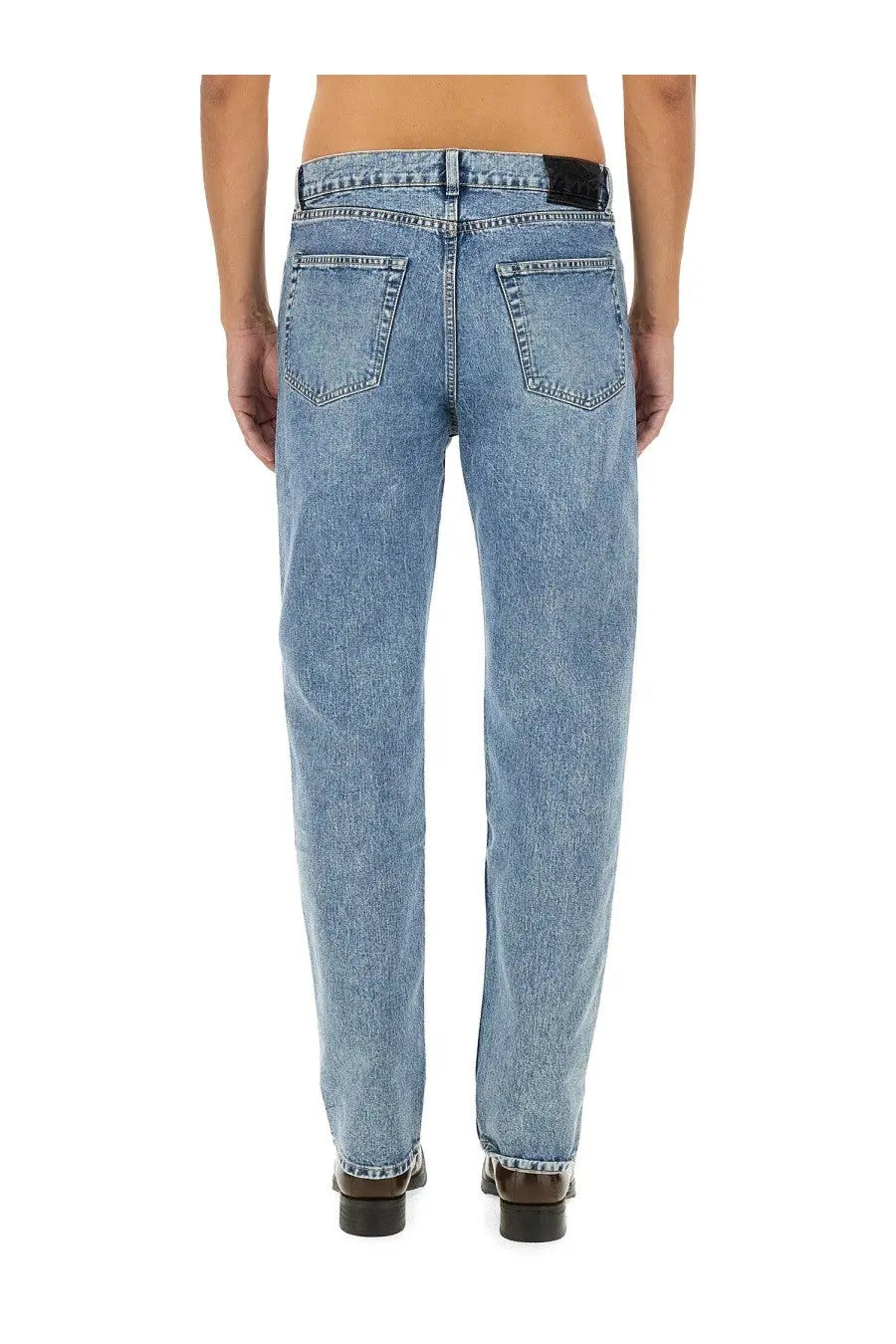 Our Legacy men’s first cut jeans blue light-wash denim with straight-leg cut and classic back pockets shown from back
