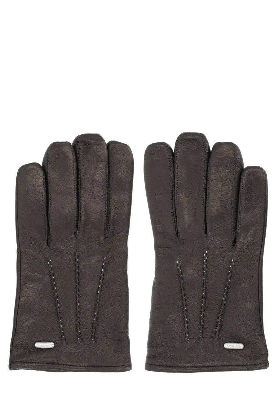 Our Legacy men’s guanti in pelle black leather gloves with subtle stitching and silver brand tags visible on the back side
