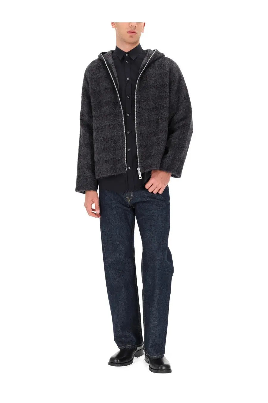 Black textured hooded jacket with silver zipper accents paired with Our Legacy men’s blue third cut jeans