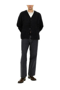 Black textured knit cardigan with button closure and front pockets paired with our legacy men’s grey jeans