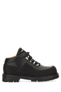 Our Legacy men’s leather quest shoe in black features suede and leather with silver toned eyelets for hiking use