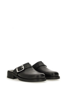 Our Legacy men’s mule camion black leather mules with silver buckle and low block heel shown from the back side